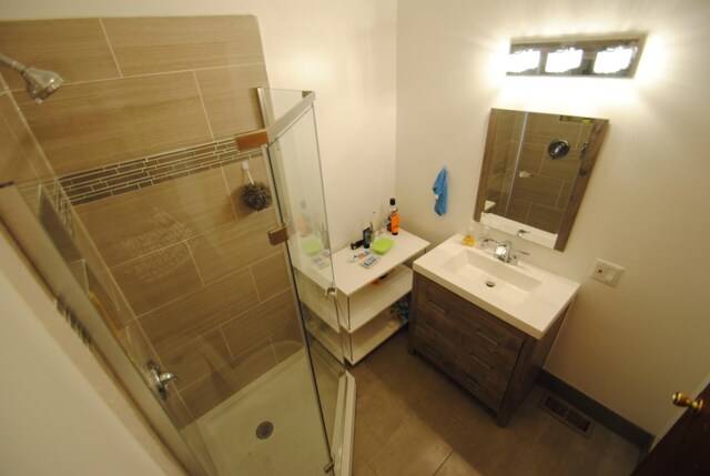 2701 W Congress Pkwy, Chicago, IL 60612 - bathroom featuring a shower stall, vanity, and tile patterned floors