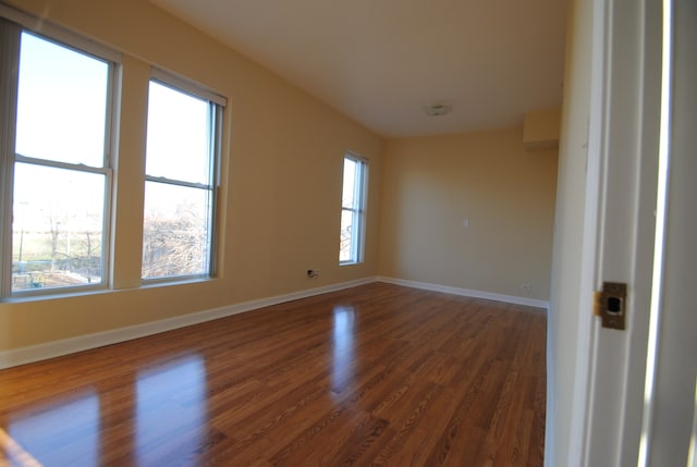 spare room featuring dark hardwood / wood-style floors