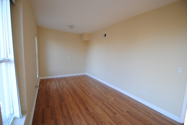 empty room with hardwood / wood-style floors