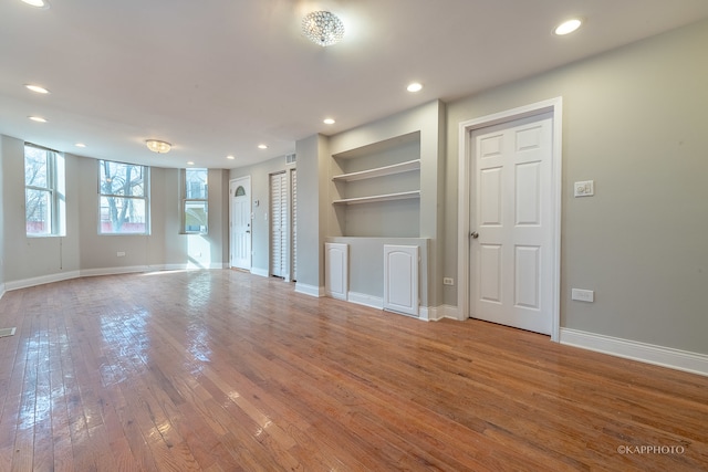 unfurnished living room with hardwood / wood-style flooring