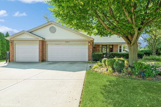 ranch-style home with a garage and a front yard