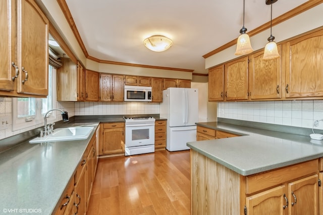 kitchen with sink, backsplash, crown molding, light hardwood / wood-style floors, and white appliances