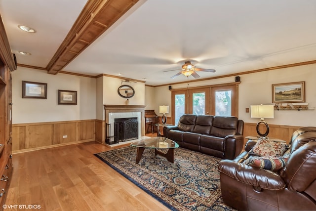 living room featuring ceiling fan, light wood-type flooring, crown molding, and french doors