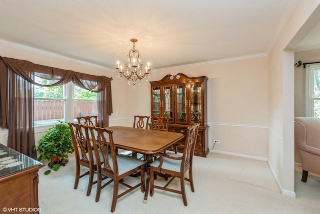 dining area with ornamental molding, plenty of natural light, light colored carpet, and an inviting chandelier