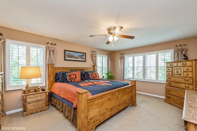 bedroom featuring light carpet and ceiling fan