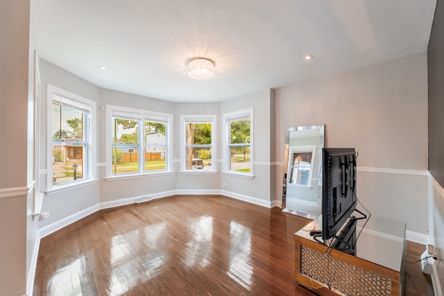 living room with hardwood / wood-style floors and a healthy amount of sunlight