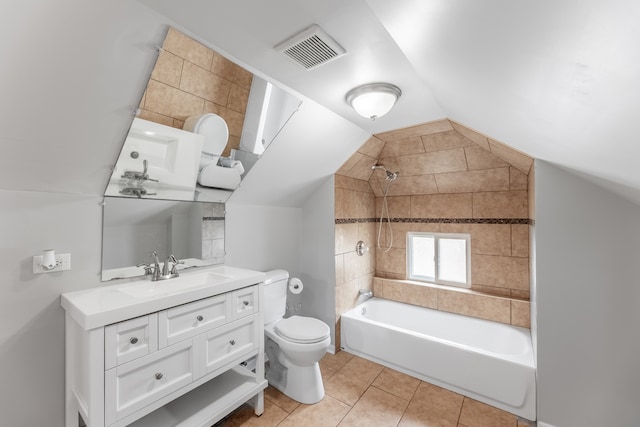 full bathroom featuring vanity, toilet, tiled shower / bath, tile patterned floors, and lofted ceiling