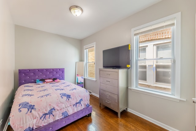 bedroom with dark wood-type flooring