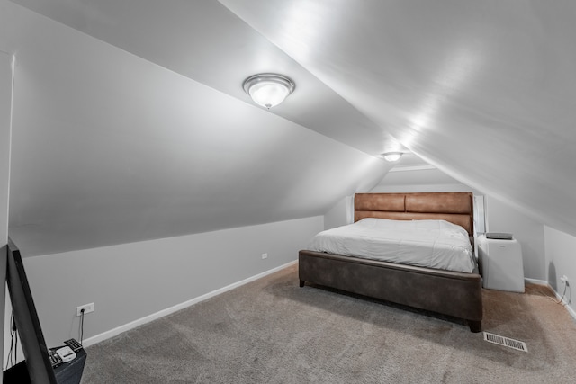 bedroom with lofted ceiling and carpet flooring