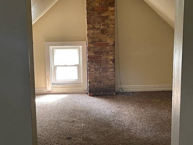 bonus room with lofted ceiling and carpet floors