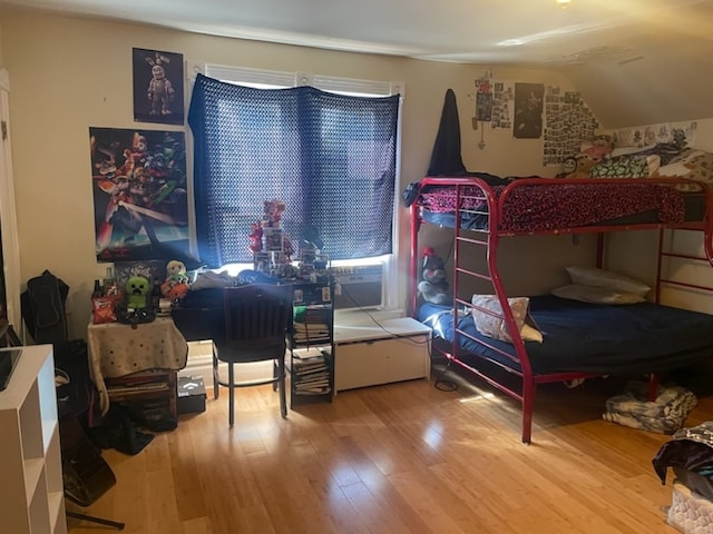 bedroom with hardwood / wood-style flooring and vaulted ceiling