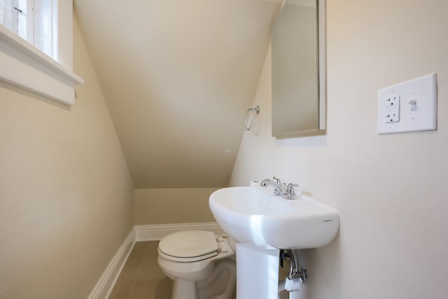 bathroom featuring lofted ceiling, toilet, and tile patterned floors