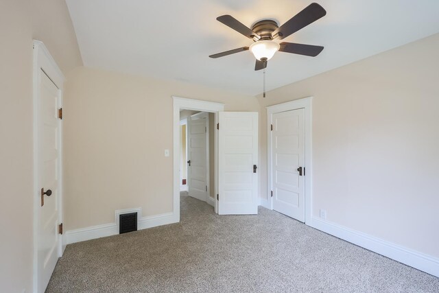 carpeted empty room featuring lofted ceiling and ceiling fan