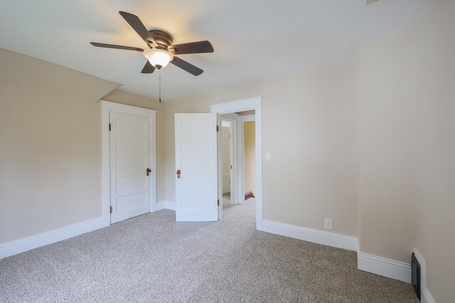 carpeted spare room featuring ceiling fan and vaulted ceiling