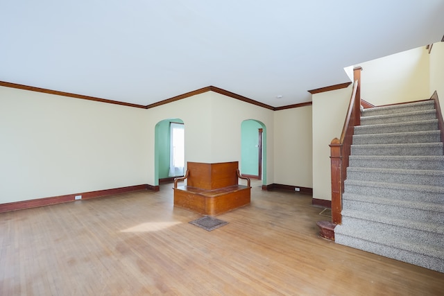 interior space with ornamental molding and wood-type flooring