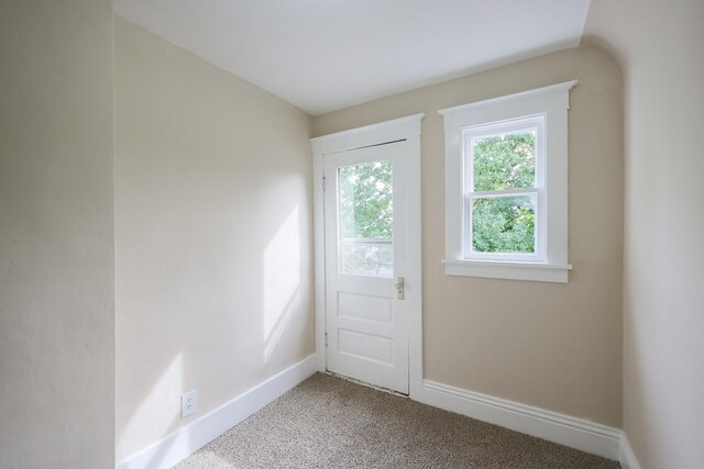 hallway featuring light carpet