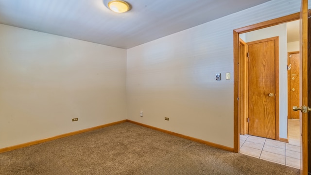 unfurnished room with light carpet