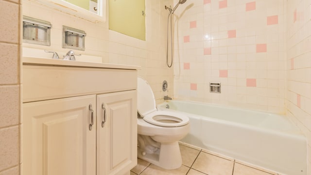 full bathroom featuring tile patterned flooring, vanity, toilet, and tiled shower / bath combo