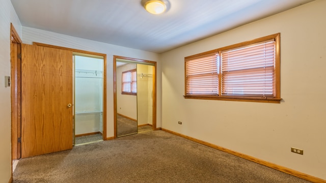 unfurnished bedroom with two closets and carpet