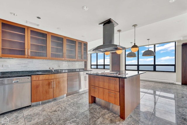 kitchen with dark stone countertops, backsplash, appliances with stainless steel finishes, a kitchen island, and island range hood