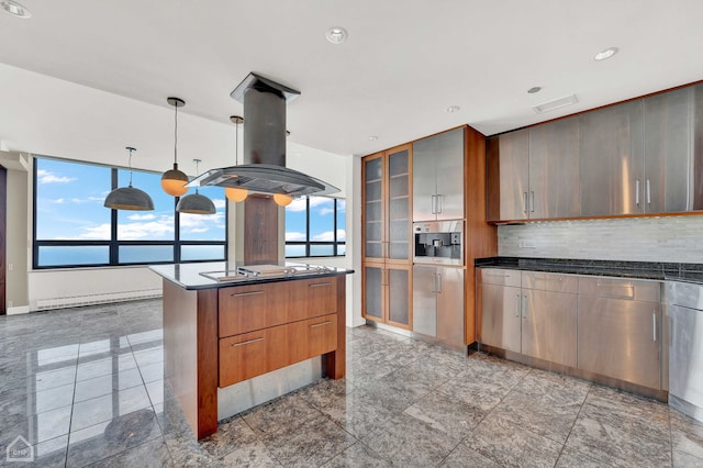 kitchen featuring a wood stove, baseboard heating, an island with sink, island range hood, and tasteful backsplash