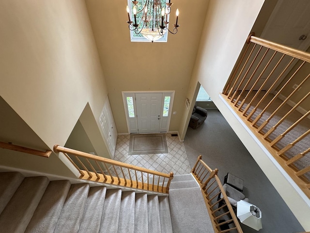 entrance foyer with a towering ceiling and an inviting chandelier