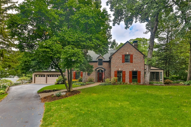 view of front of house with a garage and a front lawn