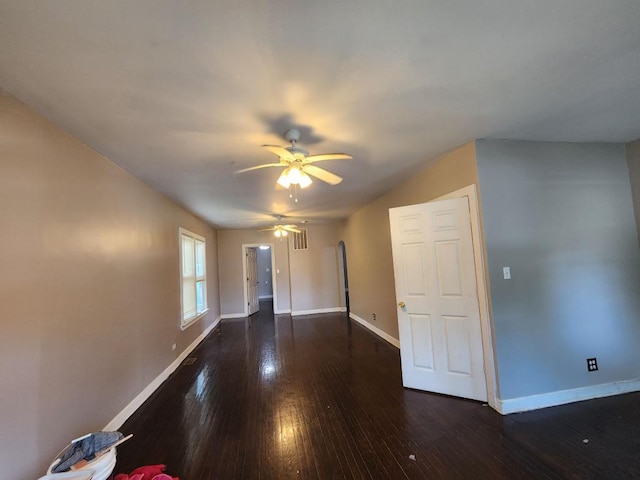 empty room featuring dark hardwood / wood-style flooring and ceiling fan