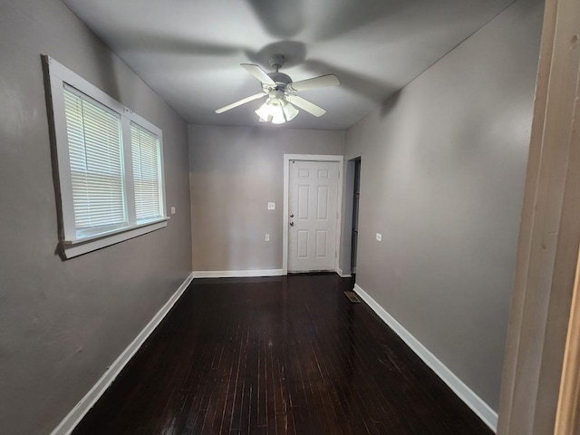 interior space featuring dark wood-type flooring and ceiling fan