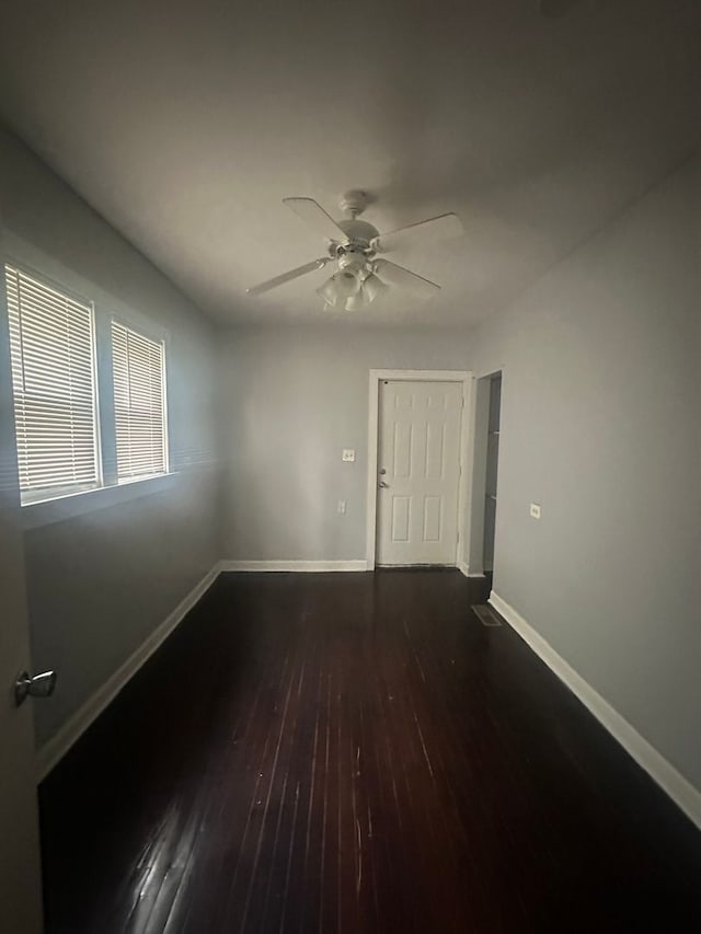 spare room with ceiling fan and dark hardwood / wood-style floors