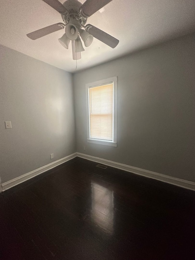 spare room with a textured ceiling, hardwood / wood-style flooring, and ceiling fan