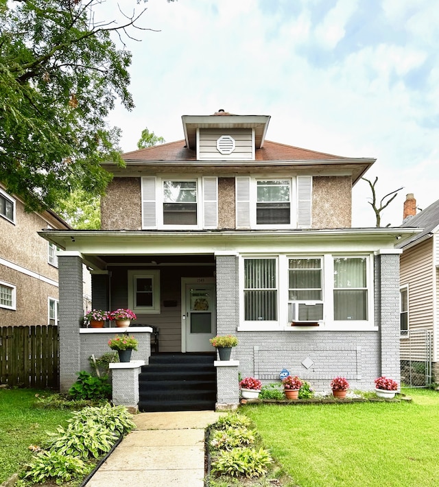 view of front of house with a porch and a front yard