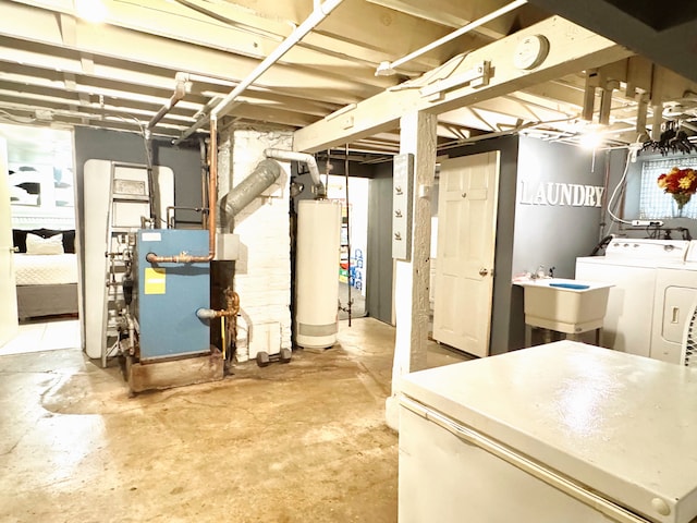 basement with gas water heater, sink, and washer and dryer