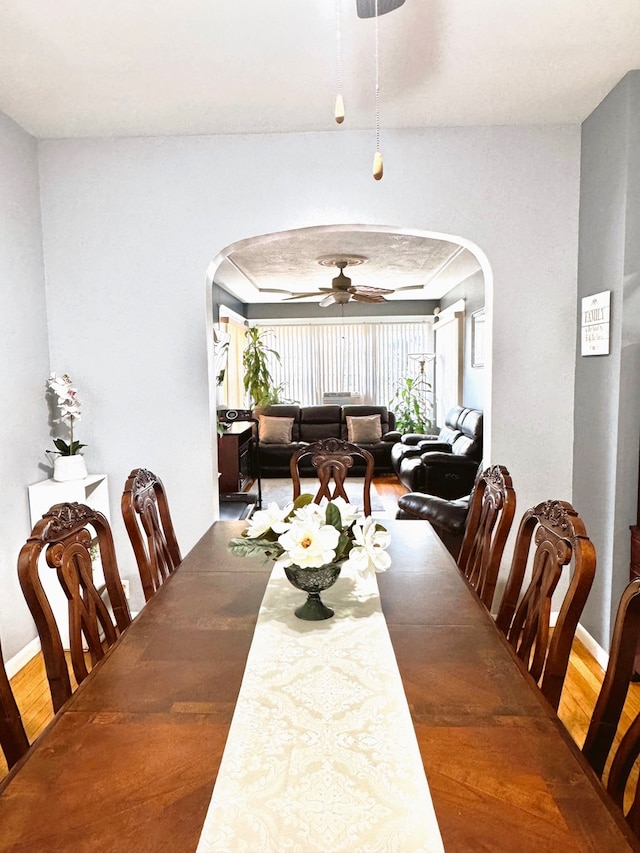 dining room with hardwood / wood-style flooring and ceiling fan