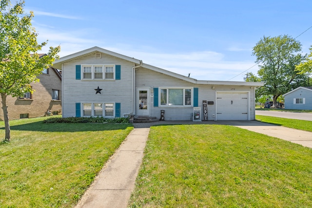 split level home with an attached garage, concrete driveway, and a front yard