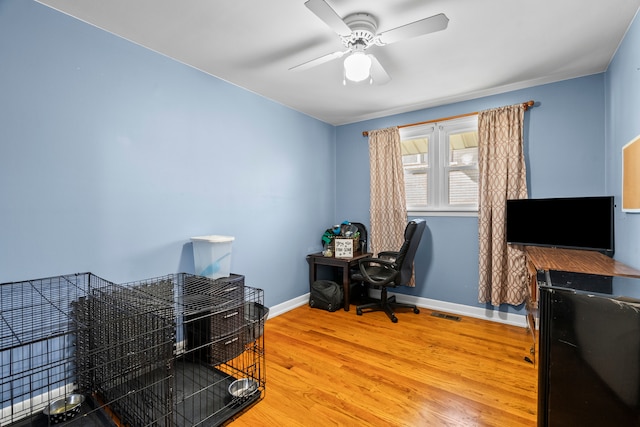 office space featuring ceiling fan and hardwood / wood-style flooring