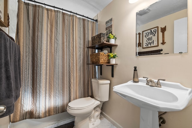 bathroom with a shower with shower curtain and toilet