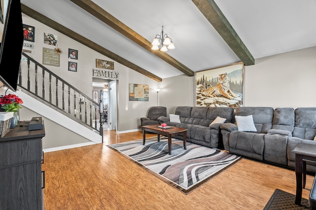 living area featuring vaulted ceiling with beams, a notable chandelier, stairway, wood finished floors, and baseboards