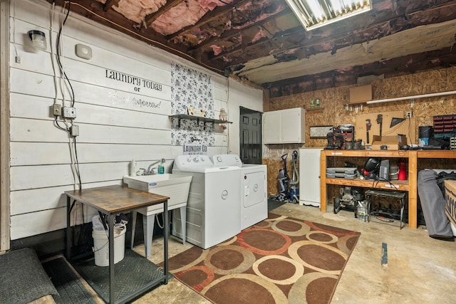 interior space featuring a workshop area, washer and clothes dryer, and sink