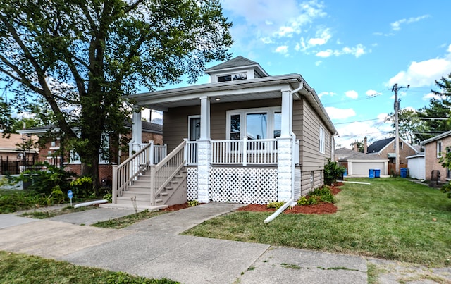 bungalow-style house featuring covered porch and a front yard