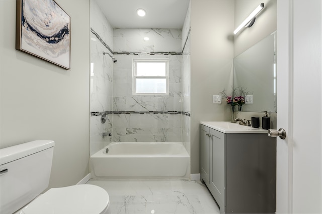 full bathroom featuring tiled shower / bath, vanity, and toilet