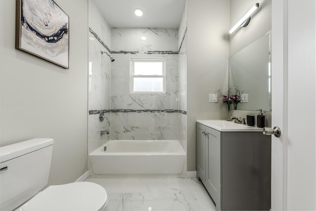 bathroom with marble finish floor, shower / bathing tub combination, toilet, vanity, and baseboards