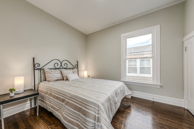 bedroom with dark hardwood / wood-style flooring and vaulted ceiling