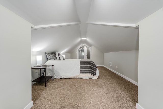 carpeted bedroom with vaulted ceiling