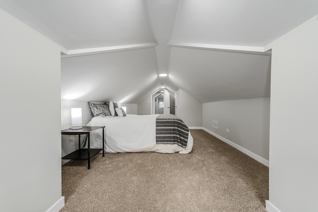 bedroom with vaulted ceiling, carpet flooring, visible vents, and baseboards