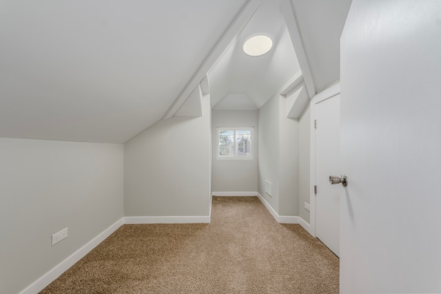 bonus room with lofted ceiling and light colored carpet