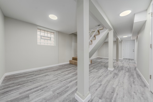 basement with light hardwood / wood-style floors