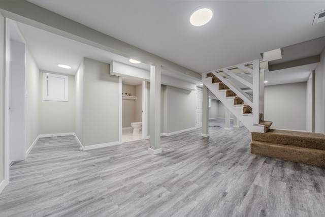 basement with light hardwood / wood-style floors