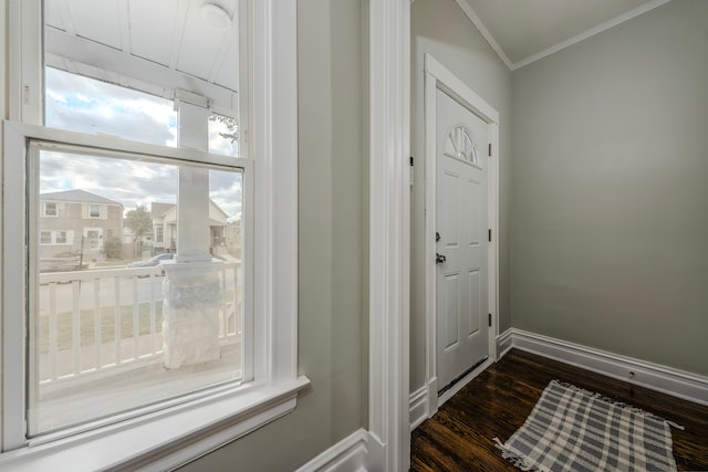 entryway with dark wood-type flooring and ornamental molding