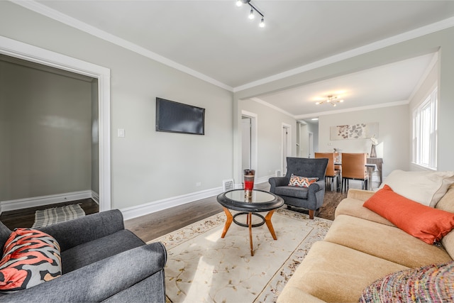 living room with light wood-type flooring, track lighting, and ornamental molding